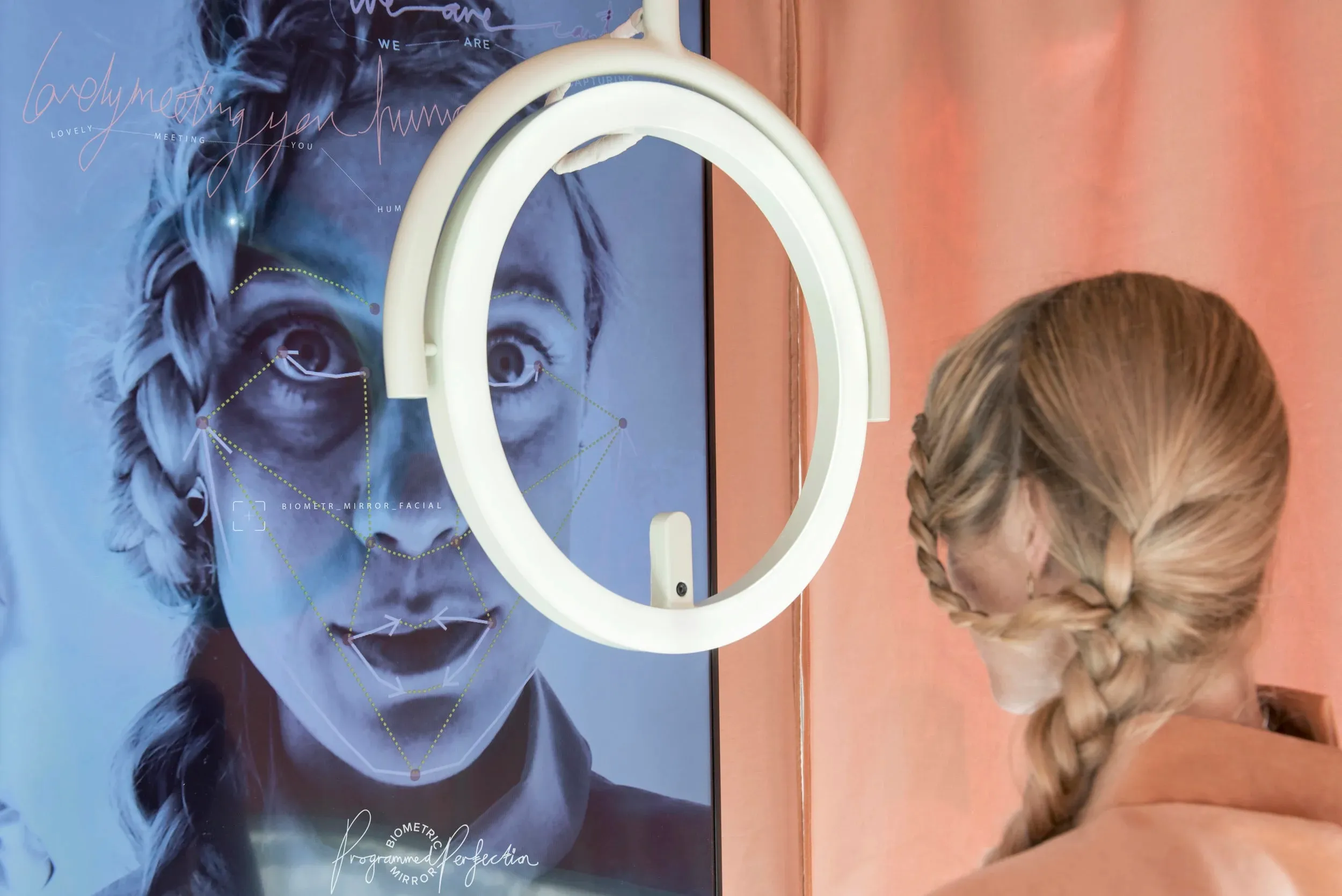 A user staring into the Biometric Mirror installation.