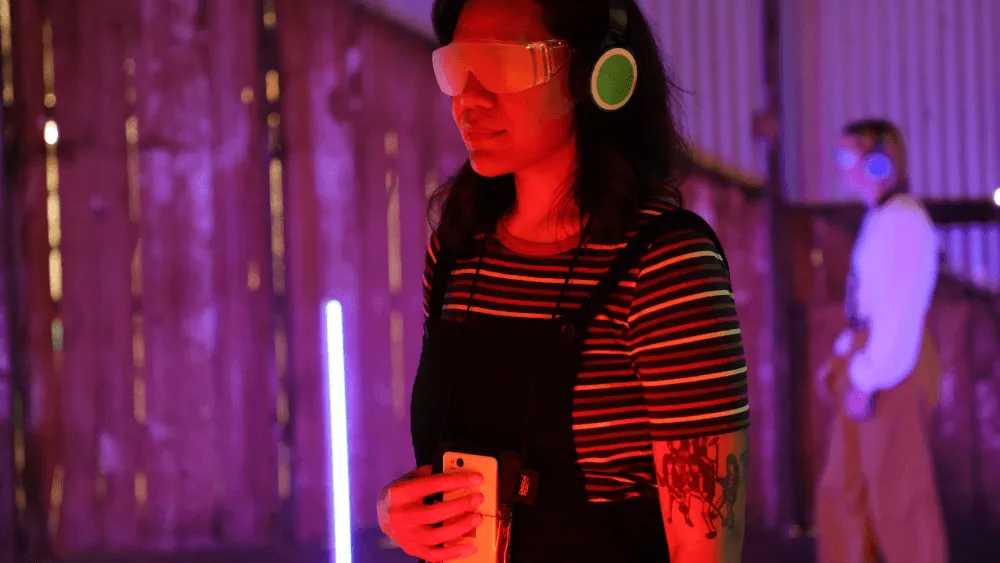 Visitors wearing headphones navigating the Invisible Orchestra space.