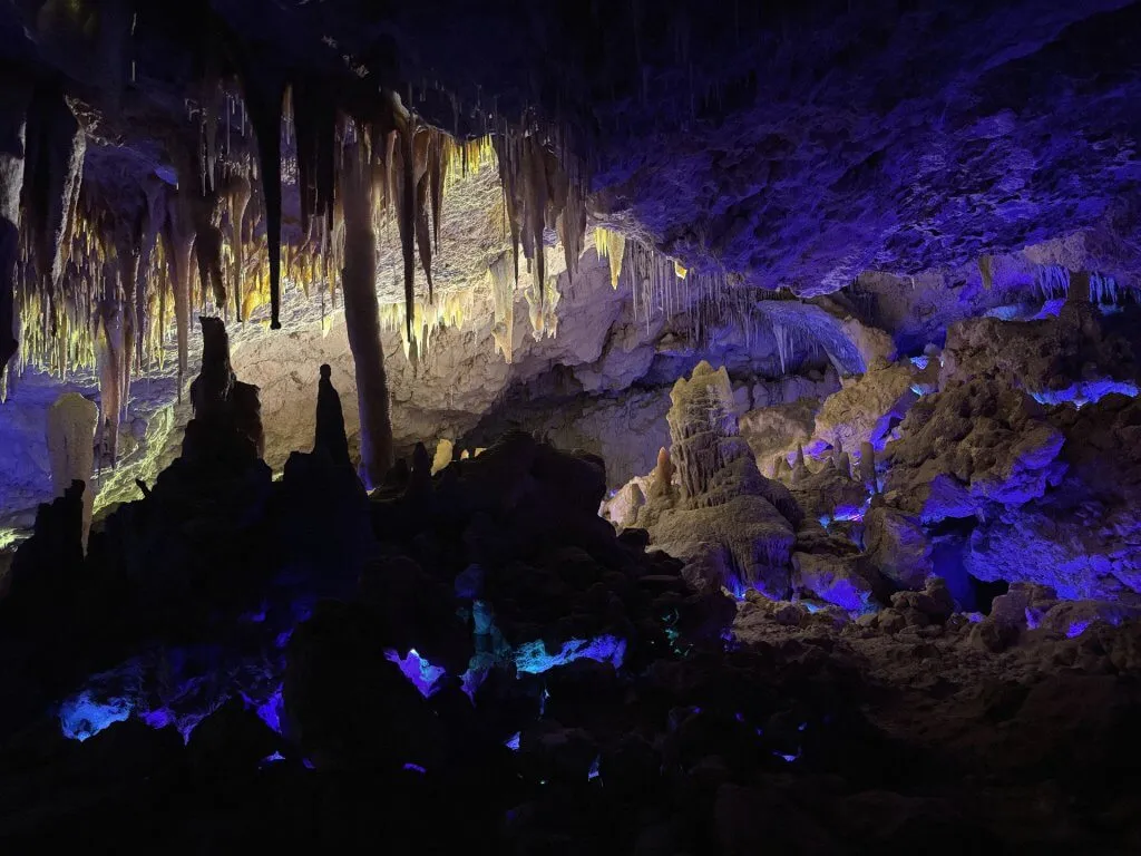 Dramatic coloured lighting illuminating the textures of Kelly Hill Caves.